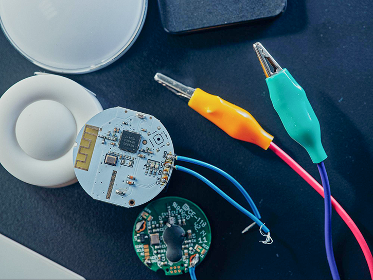 A round-shaped printed circuit board of a customizable GPS tracking system.
